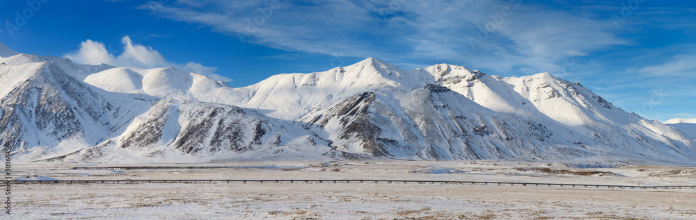 Panorama of the Alyeska crude oil pipeline running through the snowy Brooks Range mountains Alaska