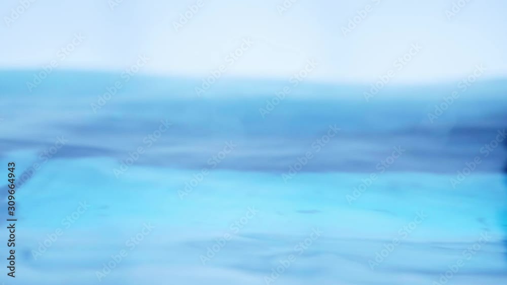 The clean water surface in slow motion fills the screen with water splashing shop the water drop and waving liquid surface with an air bubble. 1080p 29.97fps The clean water surface in slow motion fills the screen with water splashing shop the water drop and waving liquid surface with an air bubble. 1080p 29.97fps