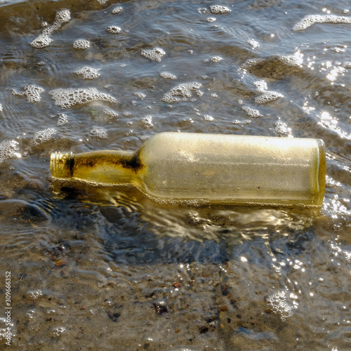 Washed up Bottle on the beach at Dead Horse Bay/Glass Bottle Beach, Barren Island, Jamaica Bay Unit of the Gateway National Recreation Area, Brooklyn, New York, USA. photo