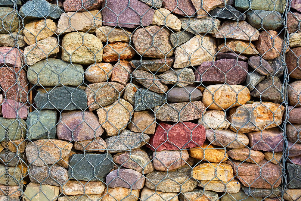 Stone Net Backing Abstract background stones in iron nets protect the beach and shore ...