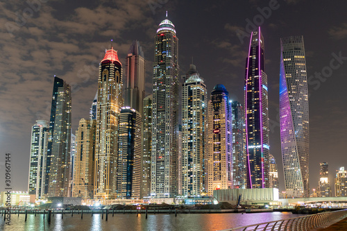 Dubai skyline at night with lights on the water and luxirious skyscrapers of UAE	 photo