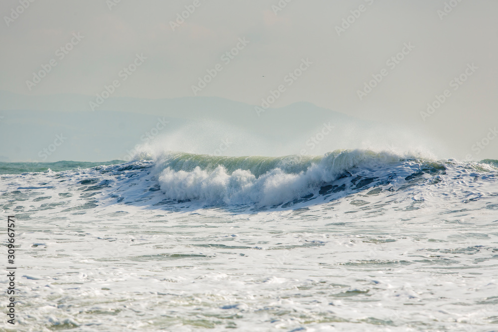 storm waves in the Black sea. The waves are in several rows, sea foam, whitecaps, wind