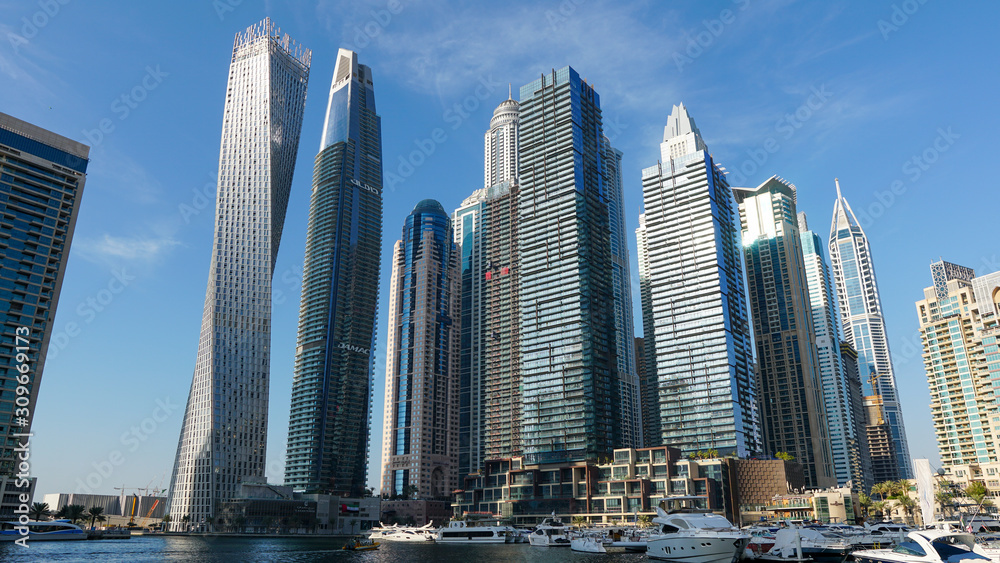 Day view of the Luxurious Dubai Marina in UAE taken at bright sunny day. Luxury lifestyle and travel.