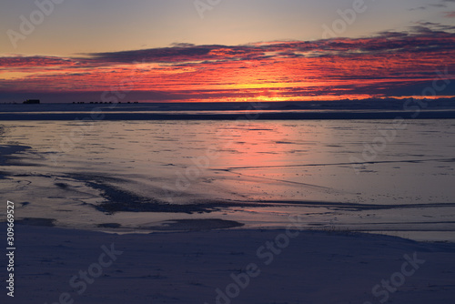 Sunrise on the frozen Sag river with distant oil wells at Deadhorse Prudhoe Bay Beaufort Sea Arctic Ocean Alaska
