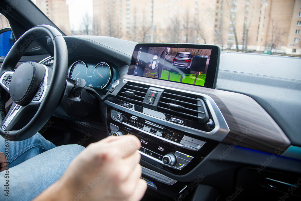 modern technology concept, road assistance. an unrecognizable man controls a 360 surround view assist system of a modern car with gestures. Close-up. modern technology concept, road assistance.