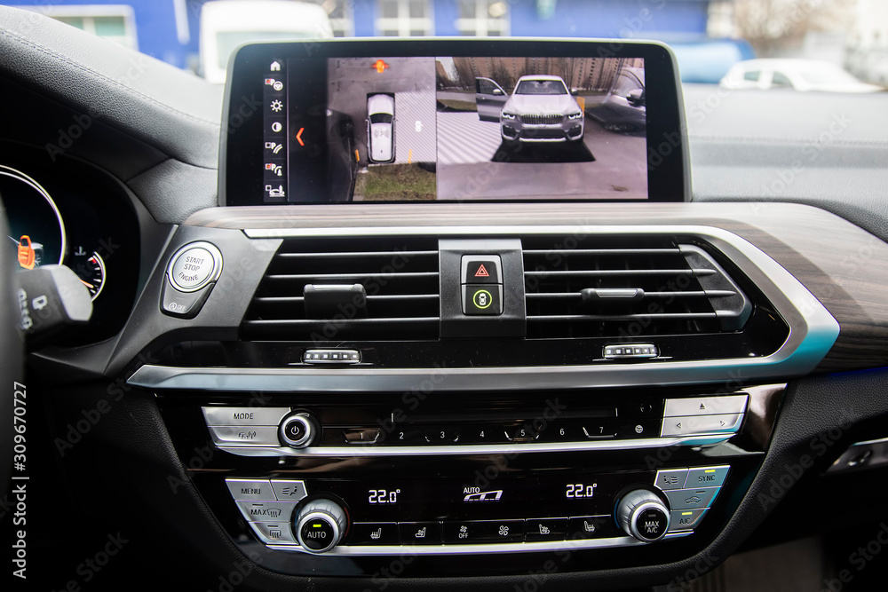 Top view, Display in interior of luxury car shows working of four cameras in surround view assist system. 360 degrees Image display on the head unit. Multimedia in the car.