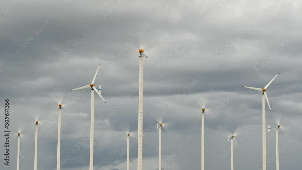 Wind turbine farm against time lapse clouds Wind turbine farm against time lapse clouds