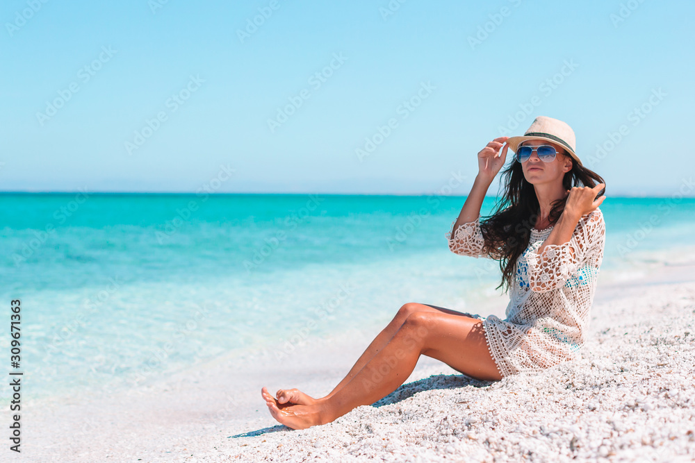 Woman laying on the beach enjoying summer holidays looking at the sea Woman laying on the beach enjoying summer holidays looking at the sea