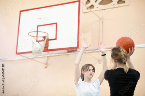 Girl in the gym playing a basketball © alexkich