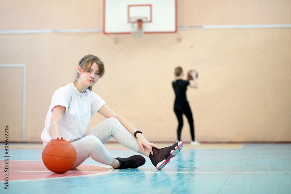 Girl in the gym playing a basketball Girl in the gym playing a basketball