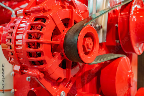 Fragment of a red diesel engine. Ship's engine. Service of cars. Motor. Drive technology. Engine production. Automotive industry. Engineering. Shipbuilding.