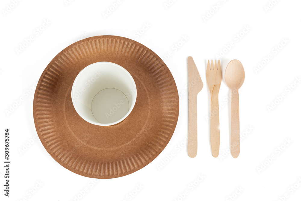 Eco - friendly plate with fork, spoon, knife and cup isolated on white background . Disposable tableware. Top view
