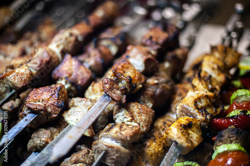 Georgian kebab. Tasty meat fried on skewers. A lot of meat cooked according to the Caucasian recipe. The work of the chef. Folk dish. Cooked over an open fire.