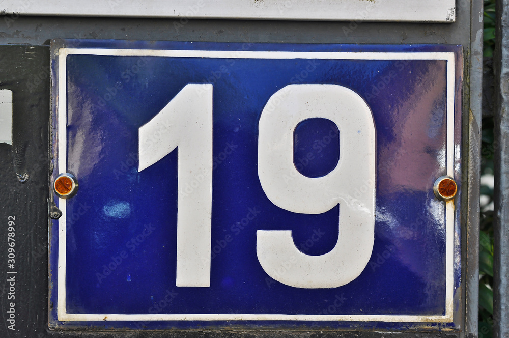A house number plaque, showing the number nineteen (19) A house number plaque, showing the number nineteen (19)