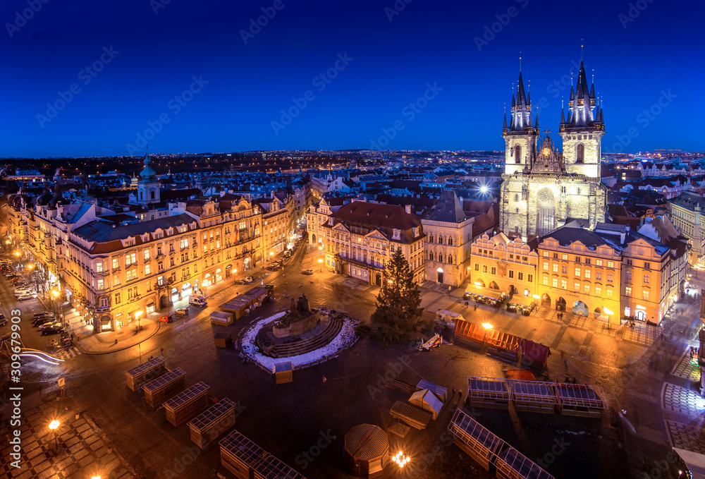 Prague Old Town Square during christmas with beautiful city lights glowing in early night with blue sky