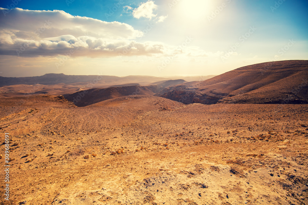 Mountainous desert with a beautiful cloudy sky. Desert in Israel at sunset