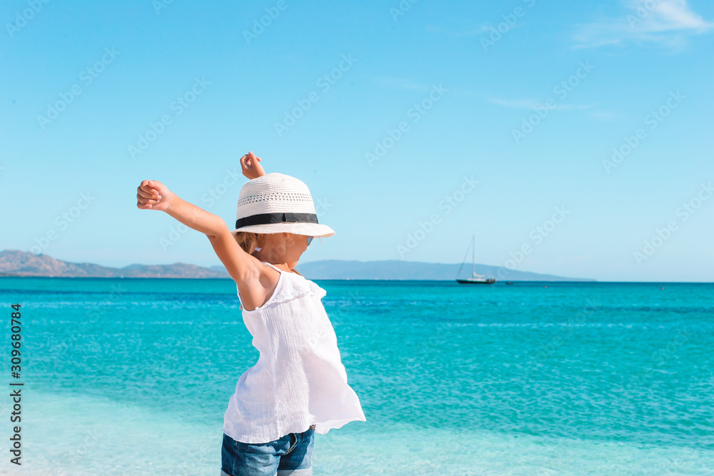 Cute little girl at beach during summer vacation Cute little girl at beach during summer vacation