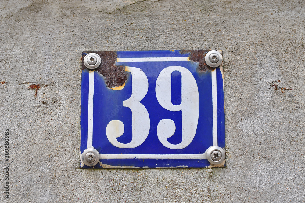 A house number plaque, showing the white coloured number thirty nine (39) A house number plaque, showing the white coloured number thirty nine (39)