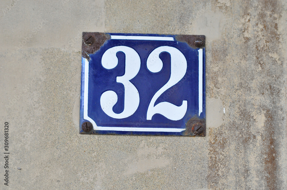 A house number plaque, showing the number thirty two (32) A house number plaque, showing the number thirty two (32)