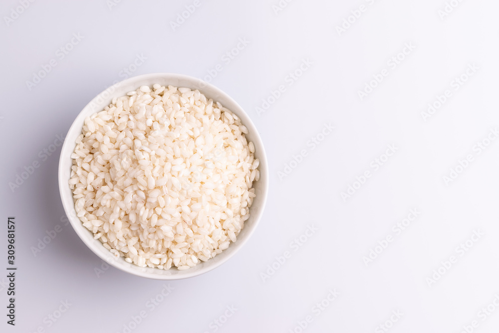 Italian Risotto rice on white background. Copy Space. Soft light. Latin term Italian Risotto rice on white background. Copy Space. Soft light. Latin term