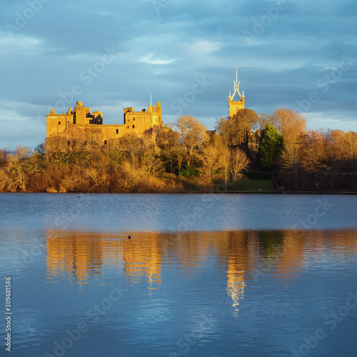 Medieval castle on the lake lit by the setting sun. Linlithgow Palace, Scotland