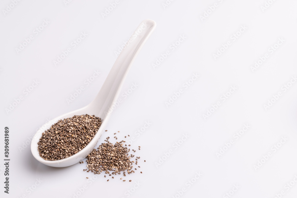 Chia seeds isolated on white background, angle view, copy space, studio shot, soft light. Latin name (Salvia hispanica). Chia seeds isolated on white background, angle view, copy space, studio shot, soft light. Latin name (Salvia hispanica).