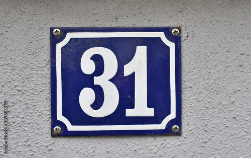 A house number plaque, showing the number thirty one (31)