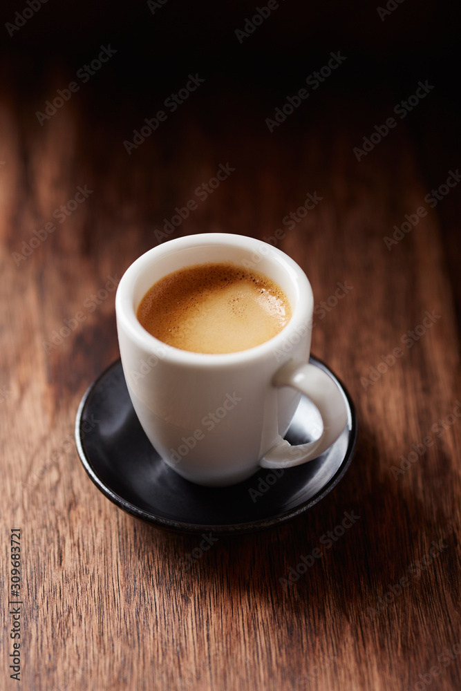 Cup of coffee on brown wooden background. Close up. Cup of coffee on brown wooden background. Close up.