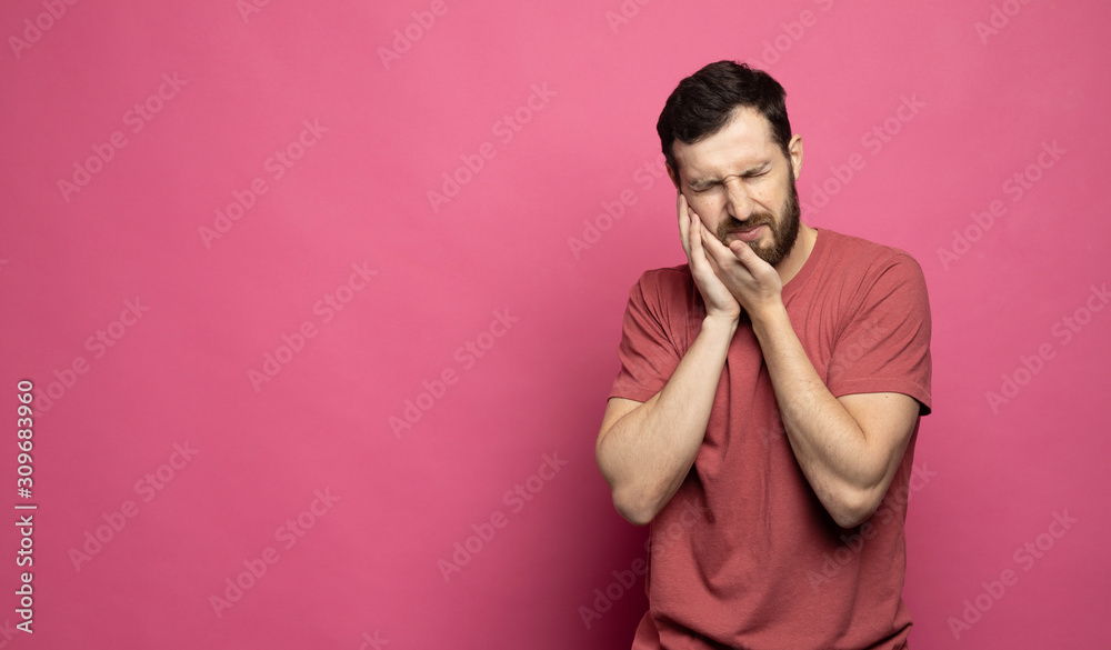 Depressed ill man having toothache and touching cheek Depressed ill man having toothache and touching cheek