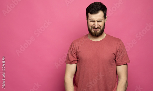 Emotional portrait of a young bearded man crying.