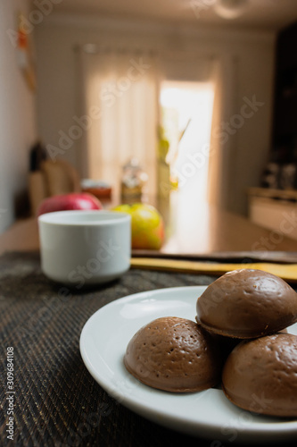 Honey bread cookie, typical Brazilian candy with cup of coffee on wooden background