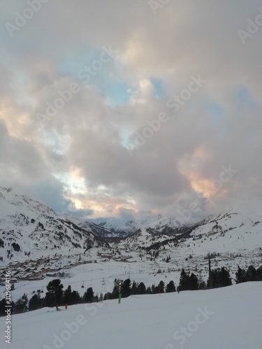 cloudy blue sky with snowed mountains