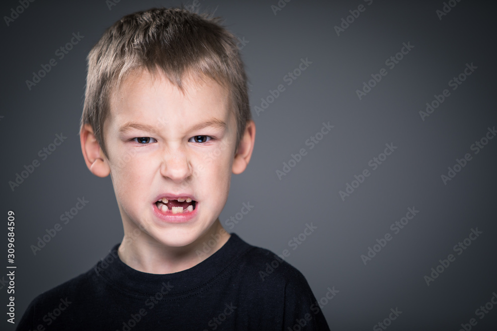 Loads of aggression in a little boy - education concept hinting behavioral problems in young children (shallow DOF) - little boy with hands clenched into fists about to punch someone Loads of aggression in a little boy - education concept hinting behavioral problems in young children (shallow DOF) - little boy with hands clenched into fists about to punch someone