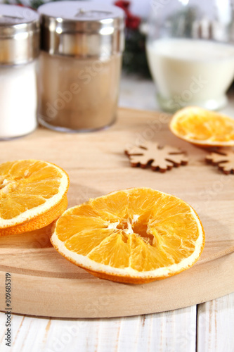 Christmas background with dry oranges and spices.