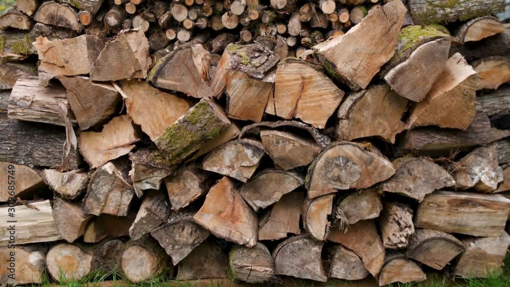 A well stocked outdoor pile of firewood.