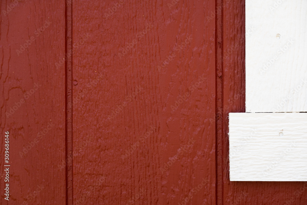 barn red wood siding of building with white trim. barn red wood siding of building with white trim.