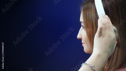 Wallpaper Mural cute young girl dancing in headphones on black background Torontodigital.ca