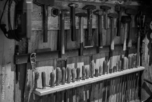 Old tools - hammers and files of different sizes, black and white photo. © Pavlo