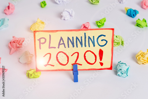 Handwriting text Planning 2020. Conceptual photo process of making plans for something next year Colored crumpled papers empty reminder white floor background clothespin © Artur