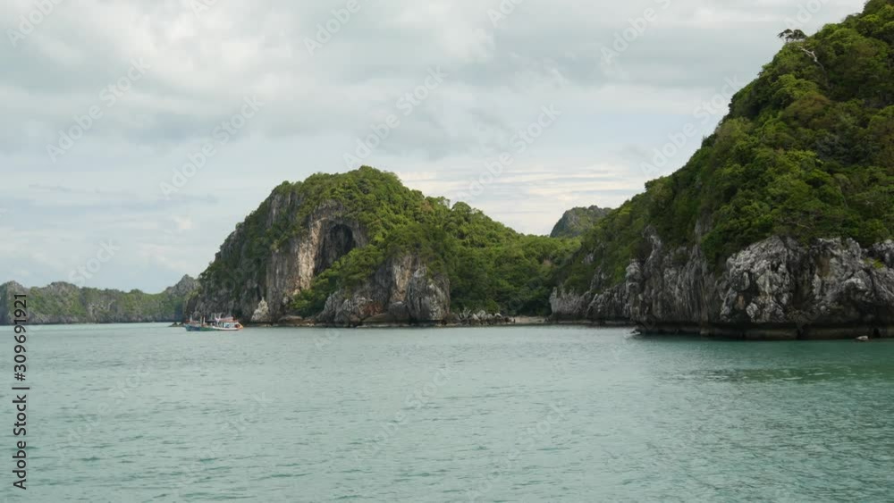 Group of Islands in ocean at Ang Thong National Marine Park near touristic Samui paradise tropical resort. Archipelago in the Gulf of Thailand. Idyllic turquoise sea natural background, copy space Group of Islands in ocean at Ang Thong National Marine Park near touristic Samui paradise tropical resort. Archipelago in the Gulf of Thailand. Idyllic turquoise sea natural background, copy space