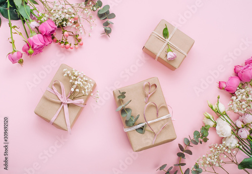 Craft paper wrapping gift boxes on pink background