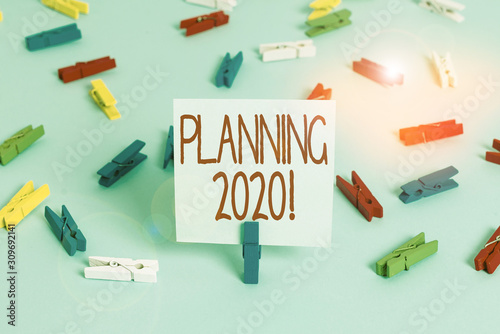 Writing note showing Planning 2020. Business concept for process of making plans for something next year Colored clothespin papers empty reminder blue floor officepin © Artur