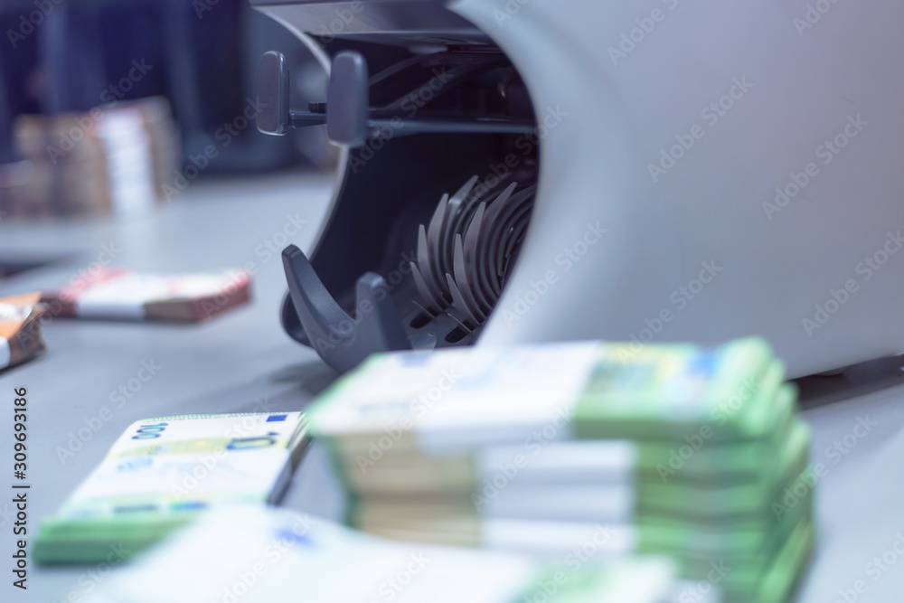 Bank employees sorting and counting money inside bank vault. Large amounts of money in the bank. Bank employees sorting and counting money inside bank vault. Large amounts of money in the bank.