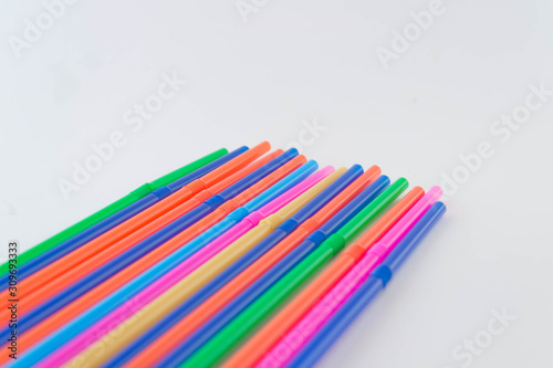 A colorful straws on a white background. Coctail equipment