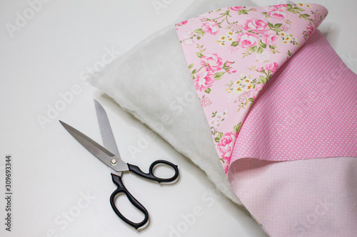 Materials and accessories for handmade. The process of hand sewing with fabric, scissors, accessories for sewing. Sewing pillows