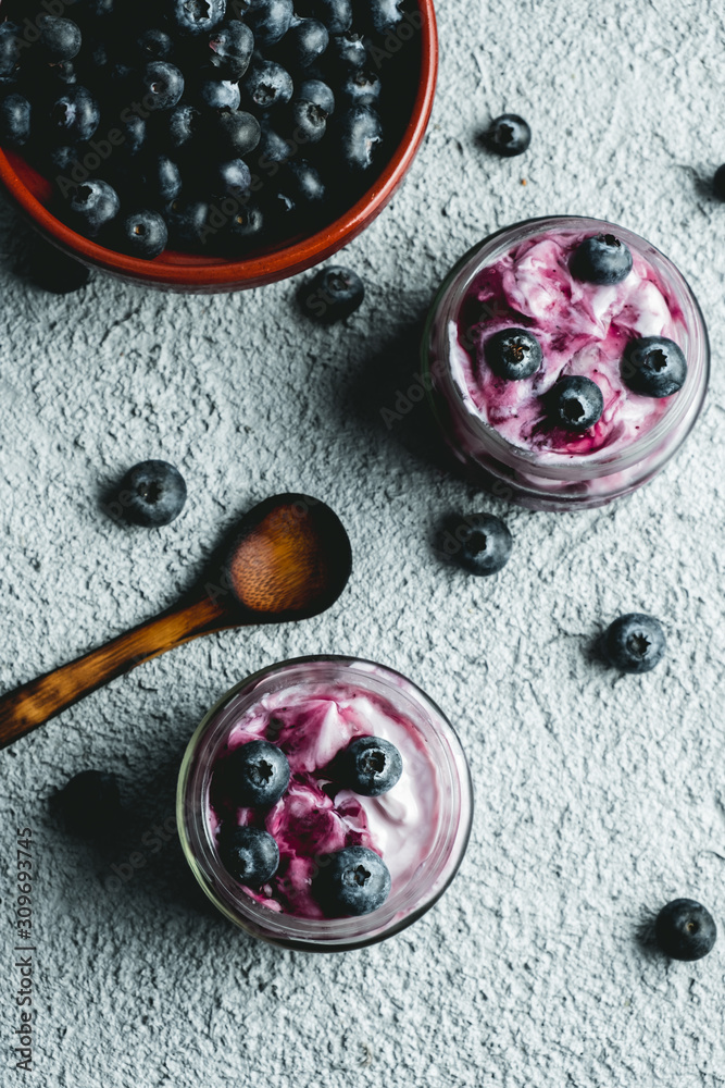 Homemade blueberry yogurt in glass bowls, healthy breakfast, selective focus. background with fresh color. Vegetarian diet