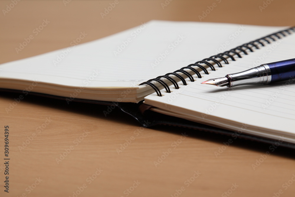 Business plan completed with pen and notebook Business plan completed with pen and notebook