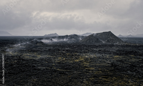 Leirhnjukur old black lava field and smoke in Iceland, overcast. Cloudy day in September 2019