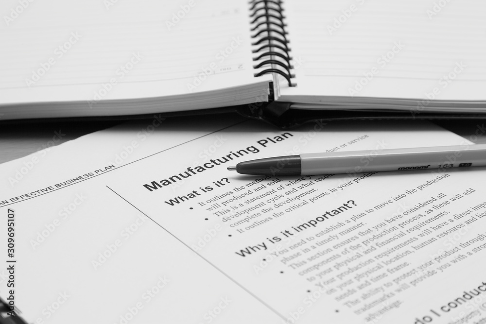 Business plan completed with pen and notebook Business plan completed with pen and notebook