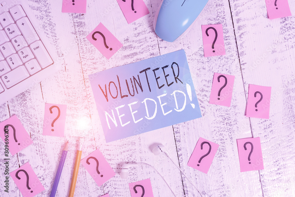 Text sign showing Volunteer Needed. Business photo text asking demonstrating to work for organization without being paid Writing tools, computer stuff and scribbled paper on top of wooden table Text sign showing Volunteer Needed. Business photo text asking demonstrating to work for organization without being paid Writing tools, computer stuff and scribbled paper on top of wooden table